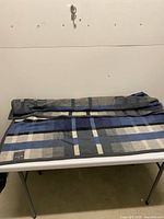 Folded plaid blanket on table showing overall pattern