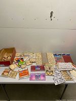 Full table view of assorted wood craft supplies and sticker sheets