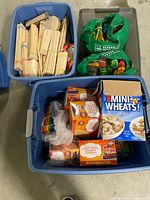 Overview showing blue tote with boxed craft sticks, green bags with colored sticks, additional tote with bundled natural sticks