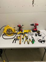 Full lot on table showing power tools, hand tools and accessories