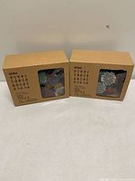 Two boxed IKEA SKINA string light sets front view