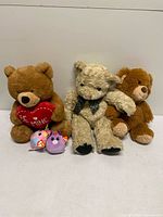 Group shot of three teddy bears and two TY unicorn Squishy Beanies