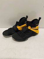 Left lateral view of both shoes showing colorway, strap system, and moderate wear