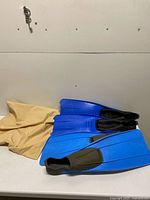 Both pairs of blue Cressi-Sub Clio fins stacked on table