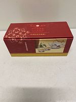 Front of red presentation box with Ten Ren Tea 20th Anniversary graphics