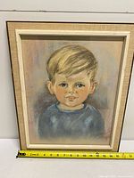 Frontal view of framed pastel portrait with measuring tape showing ~17 in width and ~21 in height