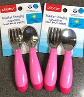 Front view showing both sealed Playtex toddler utensil packs