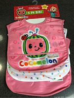 Front view of packaged 3-pack bibs showing main design