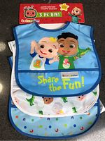 Front view of three bibs in packaging showing designs and branding