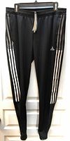 Full view of Adidas Tiro black track pants front side