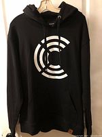 Front of black Bardown hoodie showing white circular logo and kangaroo pocket