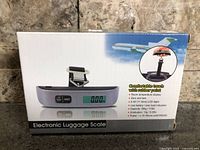 Front of retail box showing electronic luggage scale image and name