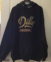 Front of black hoodie showing Dilly @THISISDILLY graphic