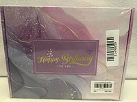 Front of sealed pastel gift box showing "Happy Birthday To You" design
