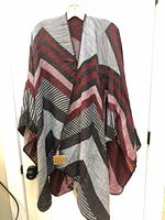 Full view of poncho scarf hanging, showing pattern and drape