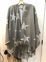 Poncho scarf front view hanging showing star pattern and fringe
