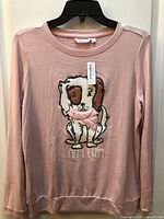 Front view of pink pajama top with puppy graphic and tag attached