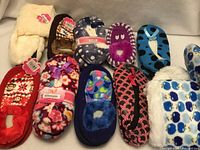 All ten pairs of assorted slippers displayed in two rows