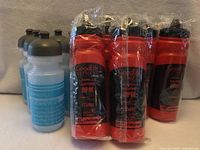 Group view of 4 Garneau and multiple red GoodLife Fitness water bottles