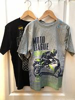 Front view of both tees on hangers