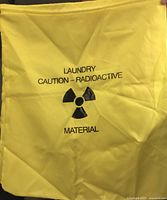 Front view of yellow bag showing caution radioactive print