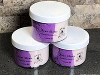 Three sealed Bear Slime jars stacked showing labels