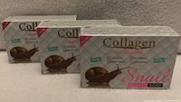 Front view showing three identical Pei Mei Collagen Snail Beauty Soap boxes
