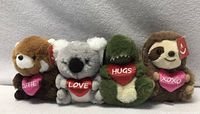 Four Aurora World plush animals in a row showing fronts and hearts