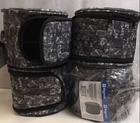 Four cylindrical Biogenik cases stacked, showing exterior stone pattern and zippers