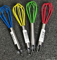 Four silicone-coated mini whisks in red, green, yellow, blue