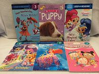 Front covers of all six books displayed upright