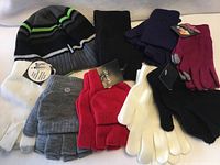 Assorted hats and gloves laid out