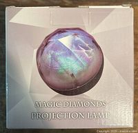 Front of unopened box showing product image and name Magic Diamonds Projection Lamp