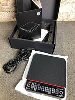 Scale wrapped in plastic wrap, USB cable, instruction manual, foam-lined box