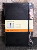 Front view of sealed black Moleskine Classic Collection ruled notebook