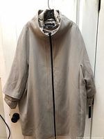 Full view of beige Nuage coat with puffer liner attached