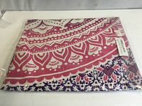 Folded pink-dominant side of tapestry in plastic