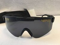 Front view of sunglasses showing lens and logo