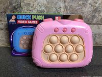 Boxed Quick Push fidget game and device front view