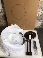 Mirror, arms, wall plate, USB cable in foam tray with box backdrop