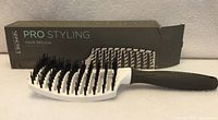 Brush displayed in front of its original box