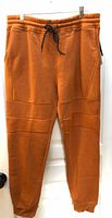 Full view of rust Southpole jogger pants with drawstring waist and ribbed knee panels