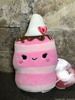 Front view of Squishmallows Shelly plush showing face, whipped cream top and tag