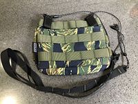 Front view of camouflage Tactical Geek mini purse with shoulder and cord straps