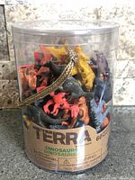 Front view of Terra by Battat dinosaur tub showing label and figures inside