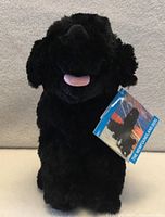 Front view of black Newfoundland dog plush with tag