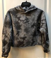 Front view showing tie-dye pattern and cropped cut with tags attached