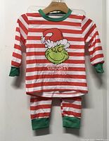 Front view of striped Grinch pyjama top and pants