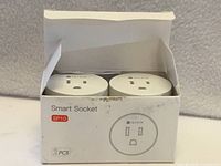 Front of open box showing two smart plugs