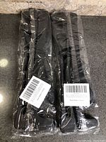 Two sealed retail packages each holding pair of gap fillers